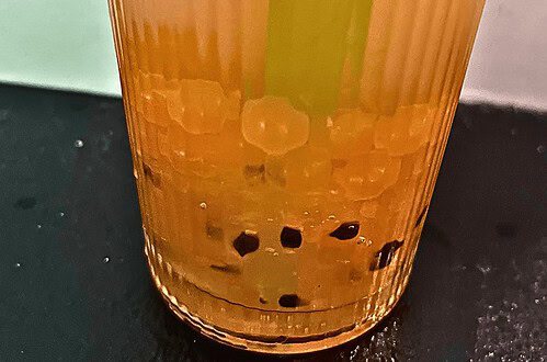 Delicious homemade mango boba tea with tapioca pearls and fresh fruit. Perfect for a refreshing trea.