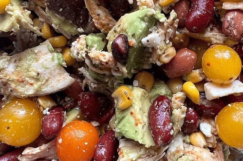 Colorful smoky chicken and bean salad with corn and avocado, vibrant and fresh.