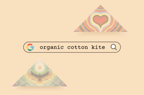 Colorful organic cotton kites with heart and rainbow patterns for eco-friendly flying.