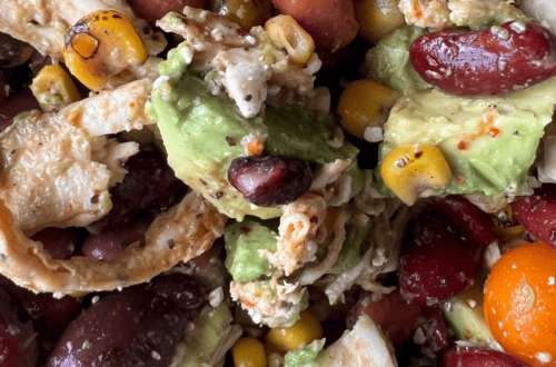 Healthy protein-packed lunch with beans, avocado, corn, and vegetables.