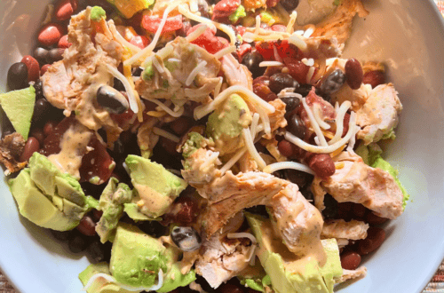 Fresh no-cook lunch protein bowl with chicken, black beans, avocado, and cheese.
