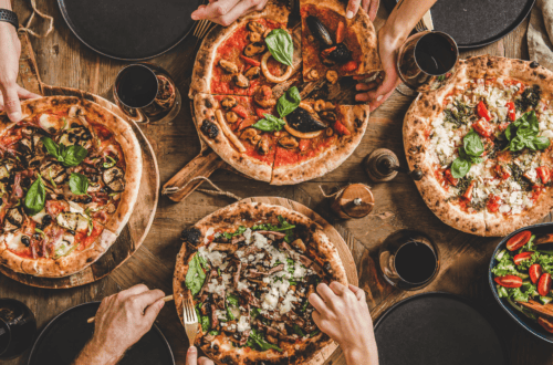 Delicious pizza, pasta, tacos, and sushi enjoyed during a cozy home food night. Perfect for sharing.