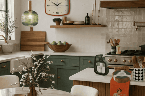 Cozy kitchen with green cabinets, white countertops, and decorative accents.