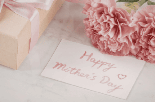Mother’s Day gift with pink flowers, gift box, and handwritten card.