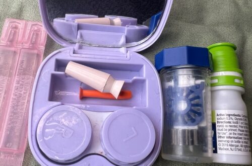 Portable medical storage case with medication bottles and supplies.
