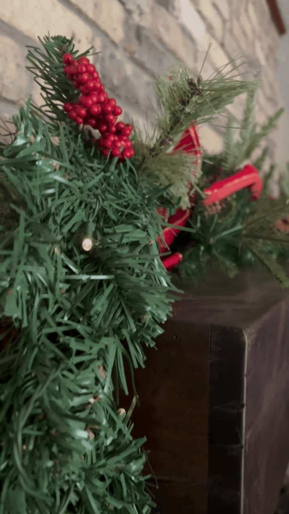 Festive Christmas greenery with red berries and ornaments for holiday decor.
