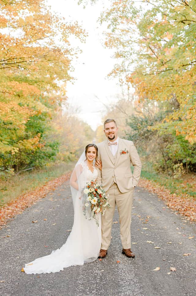Couple walking a tree-lined path at Strathmere wedding venue in North Gower
