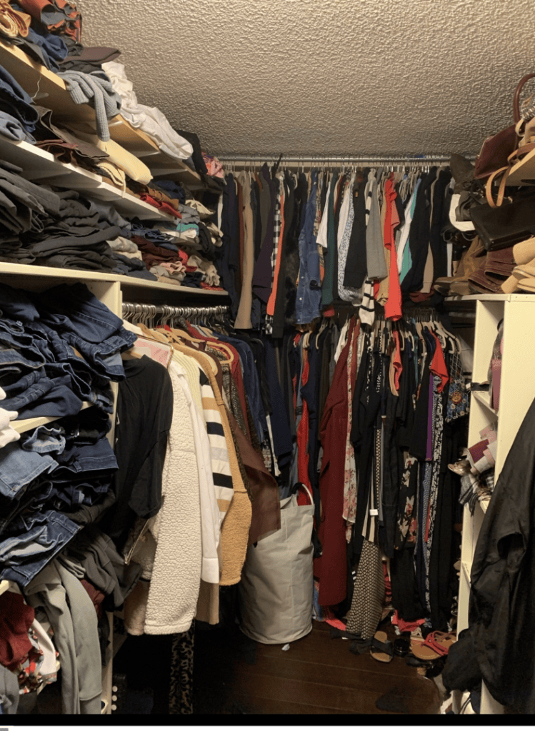 Closet with clothes and accessories organized on shelves and hangers.