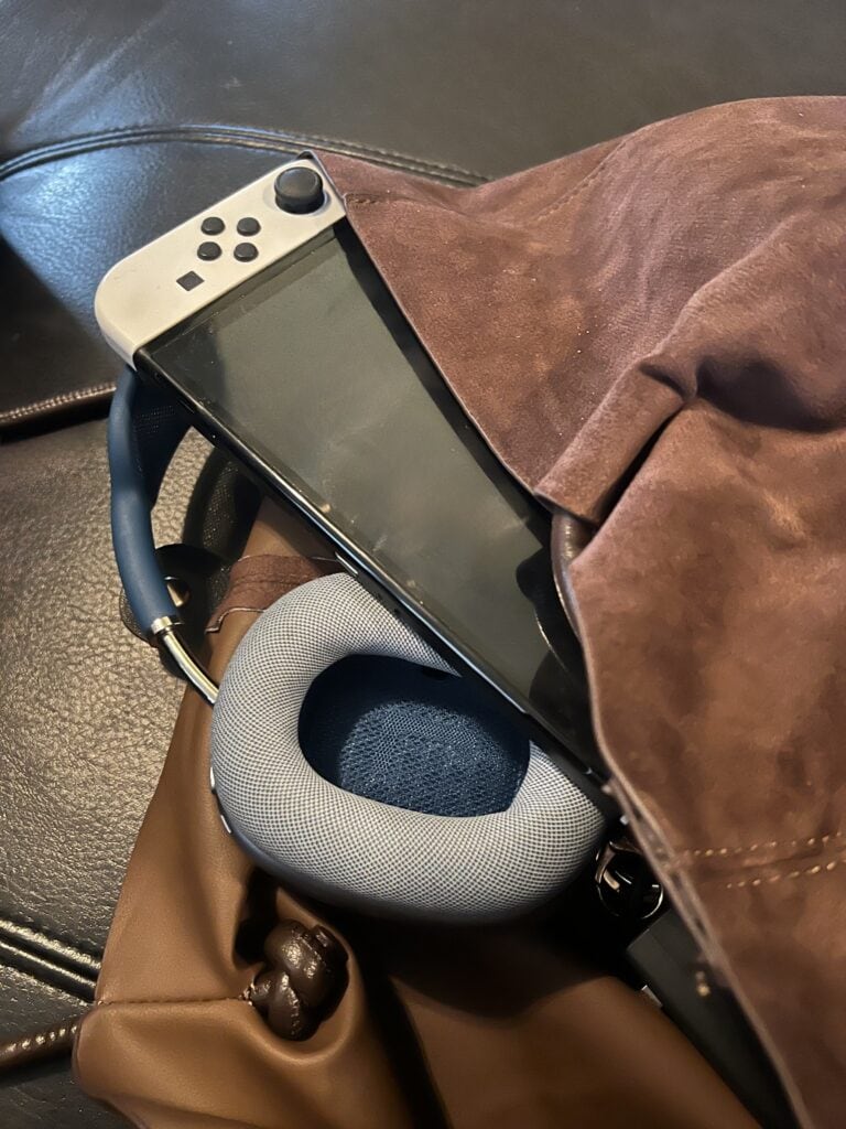 Close-up of gaming headset and Nintendo Switch in a bag.