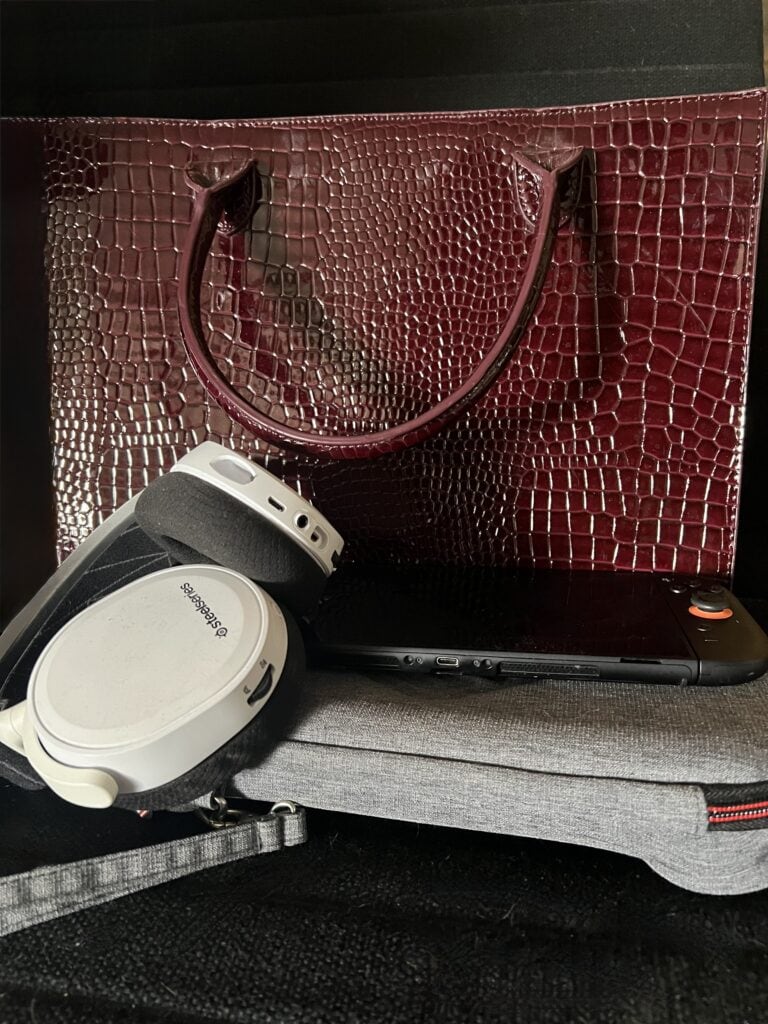 Elegant red crocodile-embossed handbag with handles for fashion accessories.
