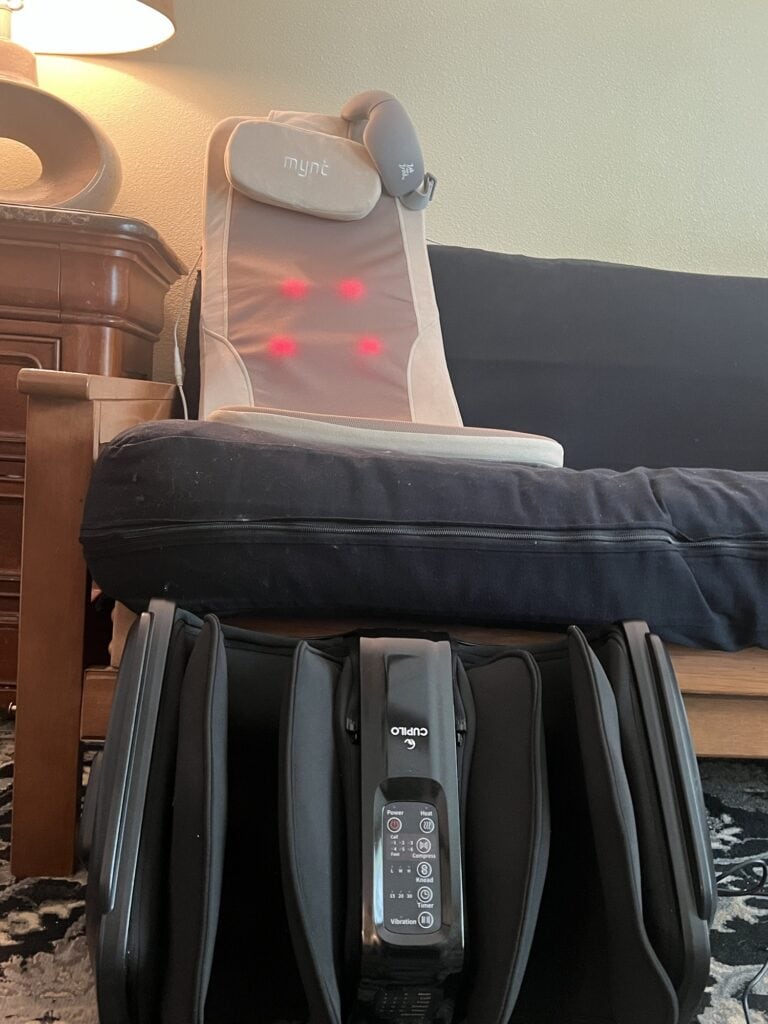 Myne massage chair with red light therapy and remote control in living room.