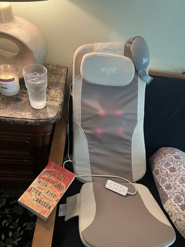 Comfortable massage chair with remote control in cozy living room.