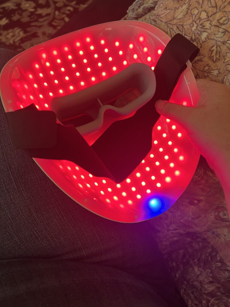 LED light therapy mask with red and blue lights for skin treatment.