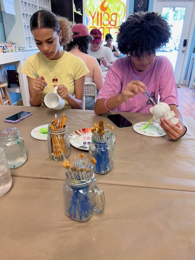 Children creating art with paint and clay at Redcypress Designs.