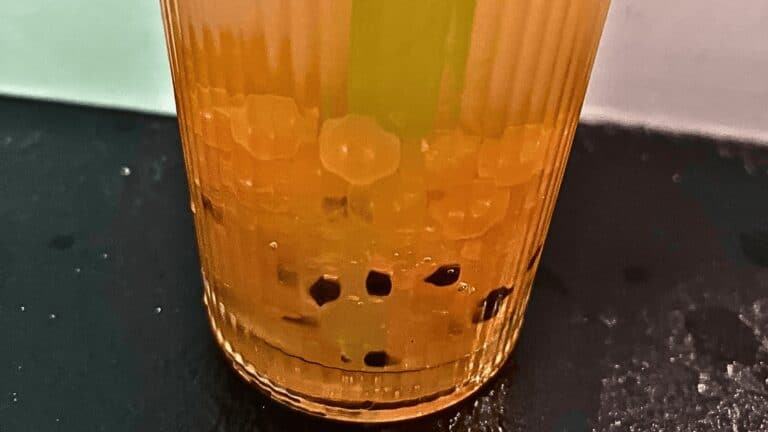 Delicious homemade mango boba tea with tapioca pearls and fresh fruit. Perfect for a refreshing trea.