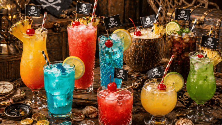 Colorful tropical cocktails with pirate flags for themed party drinks.