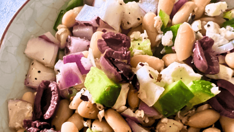 Colorful Mediterranean bean salad with vegetables and beans close-up.