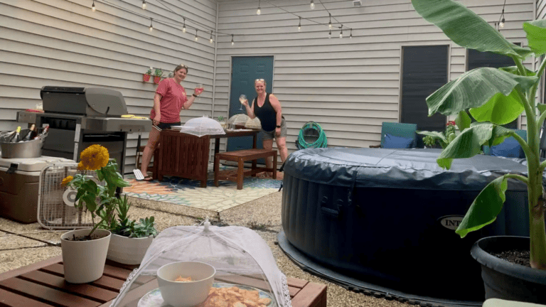 Family enjoying outdoor space with hot tub and seating area.