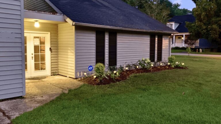 Contemporary house exterior with well-maintained lawn and garden.
