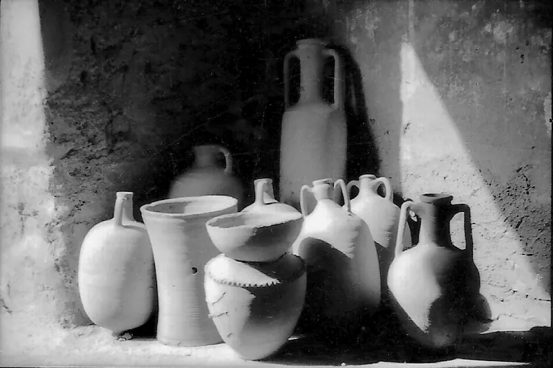Collection of ceramic vases and pots in black and white photography.