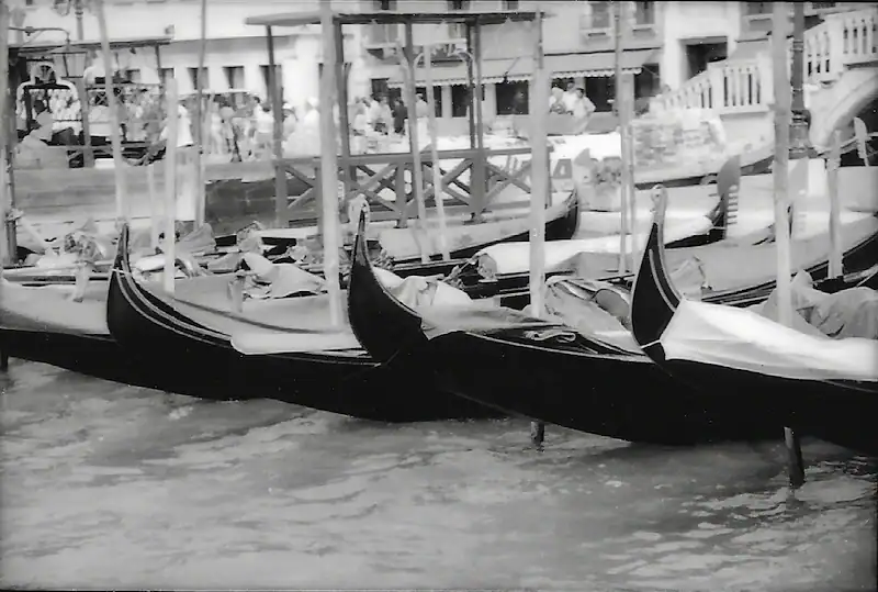 Traditional Venetian gondolas moored at a canal in Venice, Italy.