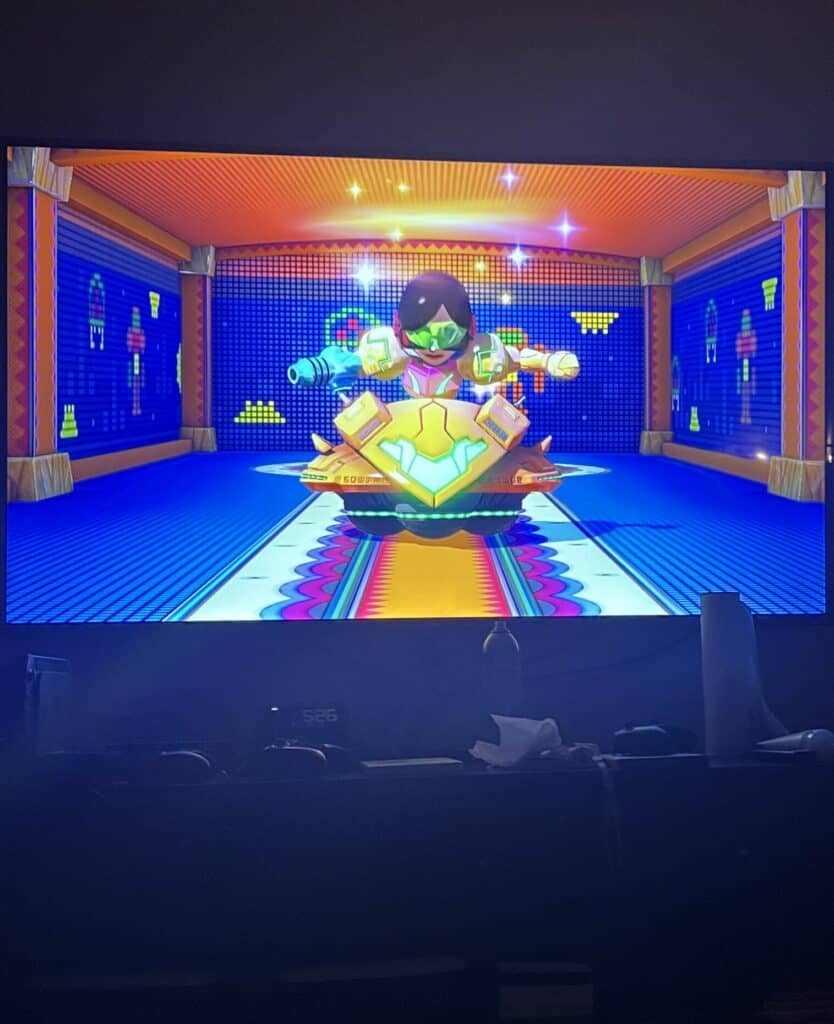 Colorful Nintendo-themed arcade game with animated characters and vibrant background.