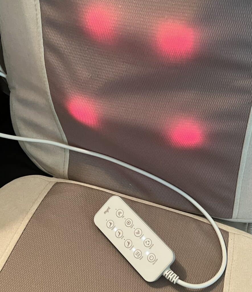 Massage chair with red light therapy panels on the backrest.