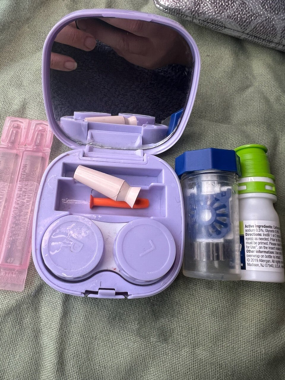 Portable medical storage case with medication bottles and supplies.