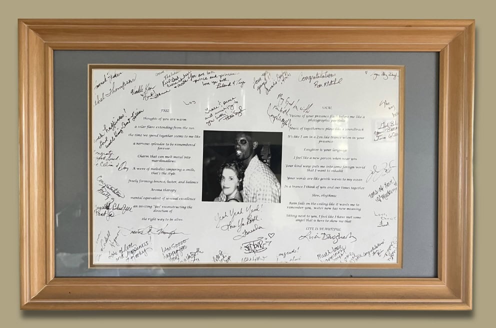 Framed collage with handwritten messages and a central photo of a couple.