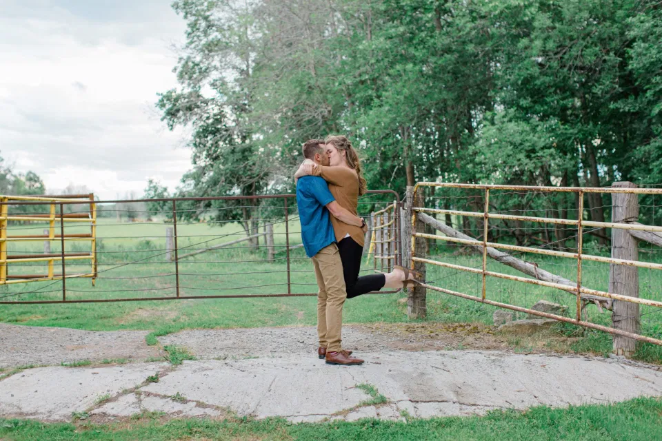 Fun on the Farm - Farm Photo Session - Farm Engagement Session - Blue and Brown Engagement Session Inspiration - Natural Engagement Session Posing - Ideas for what to wear for Engagement Photography, Modern Engagement Session Inspiration Wardrobe Ideas. Unsure of what to wear for your engagement photos, we've got you! Romantic brown with black leggings for Summer Engagement in Almonte. Grey Loft Studio is Ottawa's Wedding and Engagement Photographer for Real couples, showcasing photos that are modern, bright, and fun.