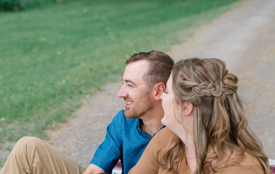 Back of the Head - Fun on the Farm - Farm Engagement Session - Blue and Brown Engagement Session Inspiration - Natural Engagement Session Posing - Ideas for what to wear for Engagement Photography, Modern Engagement Session Inspiration Wardrobe Ideas. Unsure of what to wear for your engagement photos, we've got you! Romantic brown with black leggings for Summer Engagement in Almonte. Grey Loft Studio is Ottawa's Wedding and Engagement Photographer for Real couples, showcasing photos that are modern, bright, and fun.