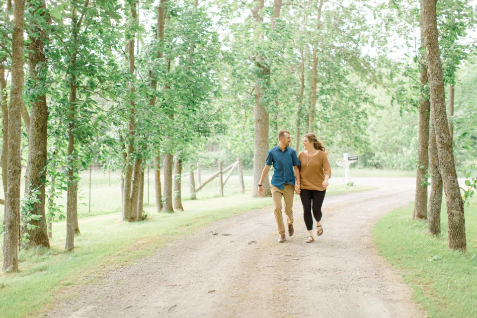 Frolic - Natural Posing for Photo Session - Couples Photo Session Fun - Fun on the Farm - Farm Engagement Session - Blue and Brown Engagement Session Inspiration - Natural Engagement Session Posing - Ideas for what to wear for Engagement Photography, Modern Engagement Session Inspiration Wardrobe Ideas. Unsure of what to wear for your engagement photos, we've got you! Romantic brown with black leggings for Summer Engagement in Almonte. Grey Loft Studio is Ottawa's Wedding and Engagement Photographer for Real couples, showcasing photos that are modern, bright, and fun.