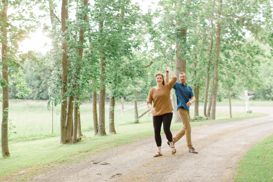 Dancing- Natural Posing for Photo Session - Couples Photo Session Fun - Fun on the Farm - Farm Engagement Session - Blue and Brown Engagement Session Inspiration - Natural Engagement Session Posing - Ideas for what to wear for Engagement Photography, Modern Engagement Session Inspiration Wardrobe Ideas. Unsure of what to wear for your engagement photos, we've got you! Romantic brown with black leggings for Summer Engagement in Almonte. Grey Loft Studio is Ottawa's Wedding and Engagement Photographer for Real couples, showcasing photos that are modern, bright, and fun.