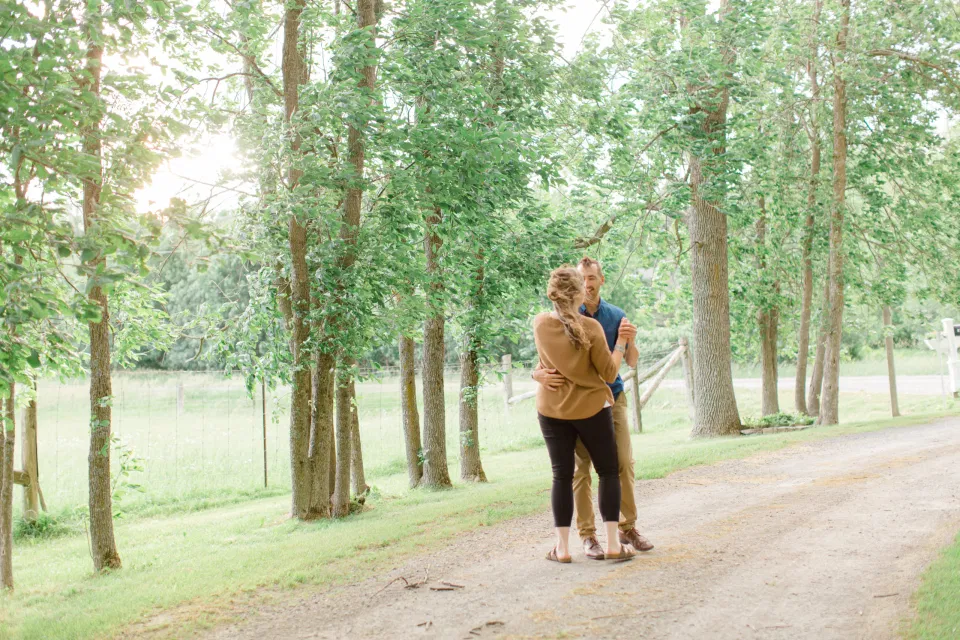 Natural Posing for Photo Session - Couples Photo Session Fun - Fun on the Farm - Farm Engagement Session - Blue and Brown Engagement Session Inspiration - Natural Engagement Session Posing - Ideas for what to wear for Engagement Photography, Modern Engagement Session Inspiration Wardrobe Ideas. Unsure of what to wear for your engagement photos, we've got you! Romantic brown with black leggings for Summer Engagement in Almonte. Grey Loft Studio is Ottawa's Wedding and Engagement Photographer for Real couples, showcasing photos that are modern, bright, and fun.
