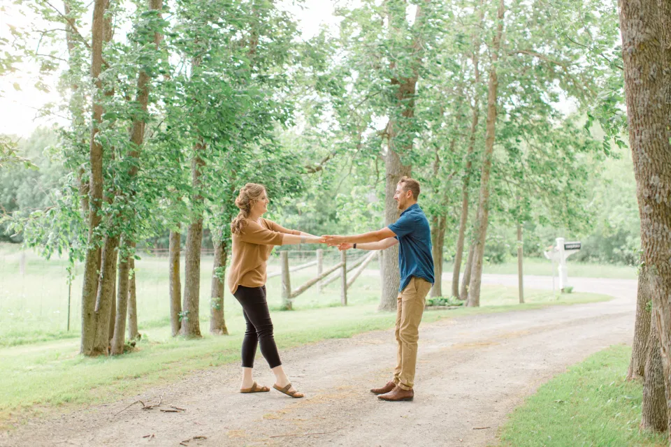 Fun Natural Posing for Photo Session - Couples Photo Session Fun - Fun on the Farm - Farm Engagement Session - Blue and Brown Engagement Session Inspiration - Natural Engagement Session Posing - Ideas for what to wear for Engagement Photography, Modern Engagement Session Inspiration Wardrobe Ideas. Unsure of what to wear for your engagement photos, we've got you! Romantic brown with black leggings for Summer Engagement in Almonte. Grey Loft Studio is Ottawa's Wedding and Engagement Photographer for Real couples, showcasing photos that are modern, bright, and fun.