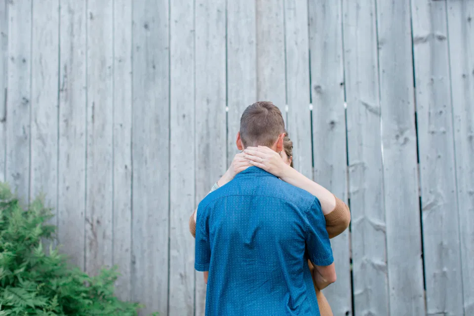 Ring shot Behind the Neck - Farm Engagement Session - Blue and Brown Engagement Session Inspiration - Natural Engagement Session Posing - Ideas for what to wear for Engagement Photography, Modern Engagement Session Inspiration Wardrobe Ideas. Unsure of what to wear for your engagement photos, we've got you! Romantic brown with black leggings for Summer Engagement in Almonte. Grey Loft Studio is Ottawa's Wedding and Engagement Photographer for Real couples, showcasing photos that are modern, bright, and fun.