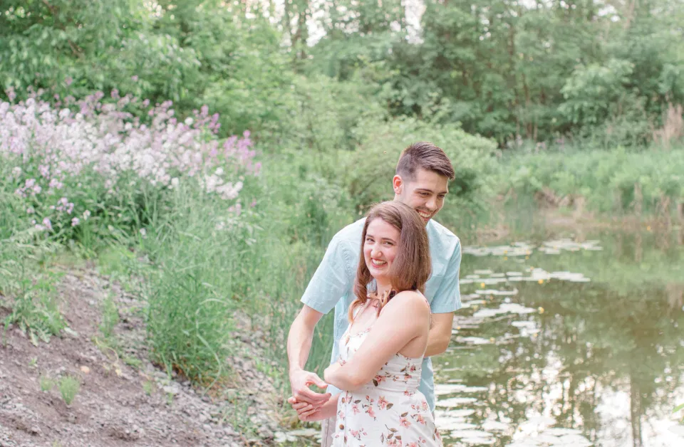 Laughing During Engagement Session - Ideas for what to wear for Engagement Photography, Modern Engagement Session Inspiration Wardrobe Ideas. Unsure of what to wear for your engagement photos, we've got you! Romantic white with Pink Flower dress for Spring Engagement in Ottawa. Grey Loft Studio is Ottawa's Wedding and Engagement Photographer for Real couples, showcasing photos that are modern, bright, and fun.