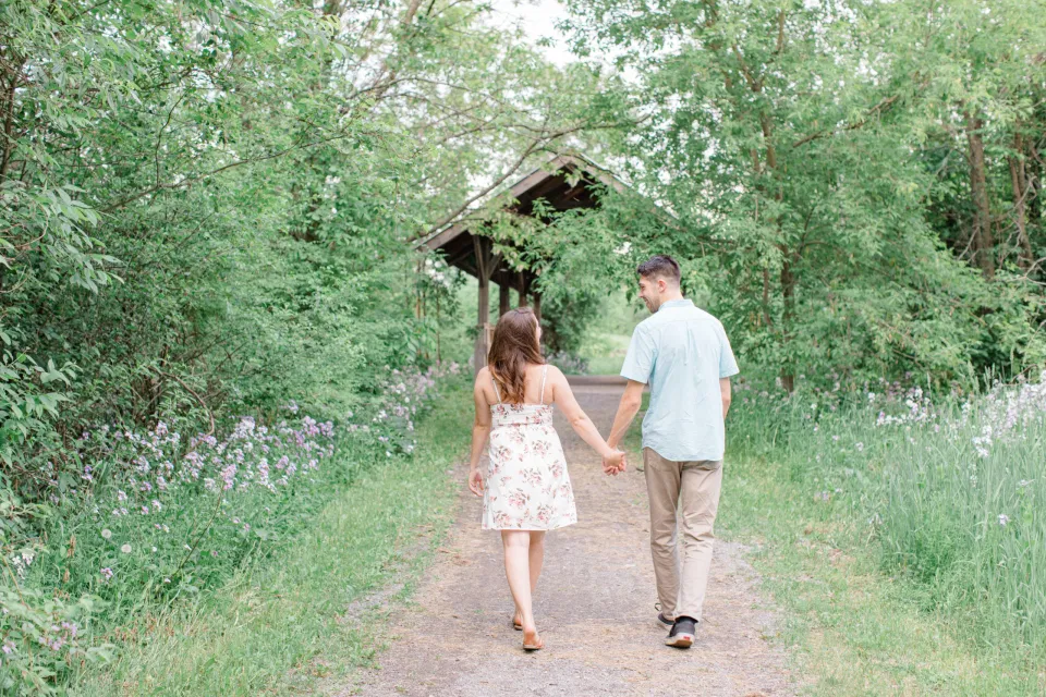 Natural Engagement Session Posing - Ideas for what to wear for Engagement Photography, Modern Engagement Session Inspiration Wardrobe Ideas. Unsure of what to wear for your engagement photos, we've got you! Romantic white with Pink Flower dress for Spring Engagement in Ottawa. Grey Loft Studio is Ottawa's Wedding and Engagement Photographer for Real couples, showcasing photos that are modern, bright, and fun.