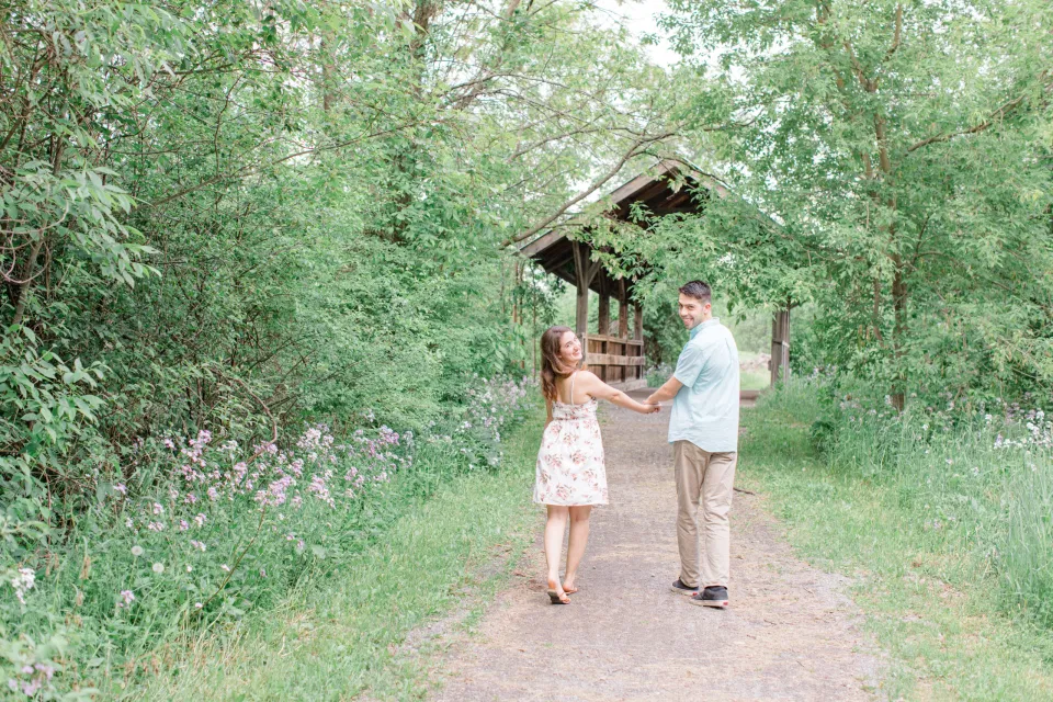 Natural Engagement Session Posing - Ideas for what to wear for Engagement Photography, Modern Engagement Session Inspiration Wardrobe Ideas. Unsure of what to wear for your engagement photos, we've got you! Romantic white with Pink Flower dress for Spring Engagement in Ottawa. Grey Loft Studio is Ottawa's Wedding and Engagement Photographer for Real couples, showcasing photos that are modern, bright, and fun.