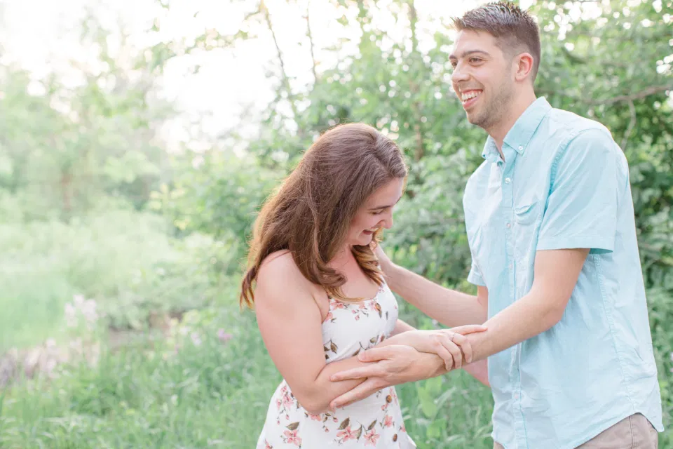 Ideas for what to wear for Engagement Photography, Modern Engagement Session Inspiration Wardrobe Ideas. Unsure of what to wear for your engagement photos, we've got you! Romantic white with Pink Flower dress for Spring Engagement in Ottawa. Grey Loft Studio is Ottawa's Wedding and Engagement Photographer for Real couples, showcasing photos that are modern, bright, and fun.