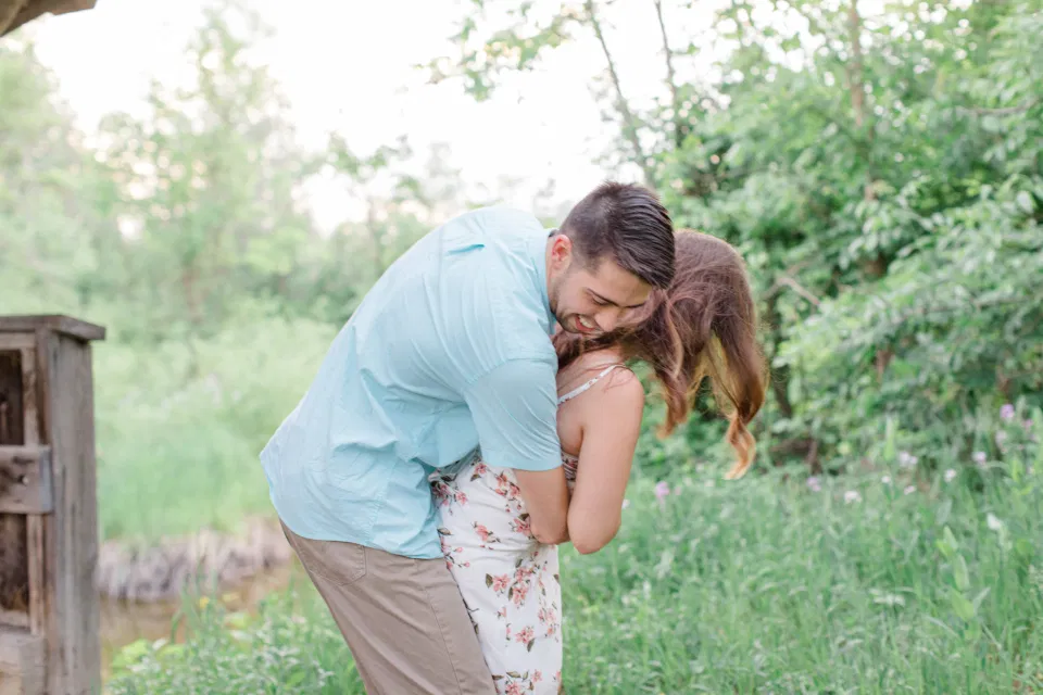Fun Photos During your Engagement Session - Ideas for what to wear for Engagement Photography, Modern Engagement Session Inspiration Wardrobe Ideas. Unsure of what to wear for your engagement photos, we've got you! Romantic white with Pink Flower dress for Spring Engagement in Ottawa. Grey Loft Studio is Ottawa's Wedding and Engagement Photographer for Real couples, showcasing photos that are modern, bright, and fun.