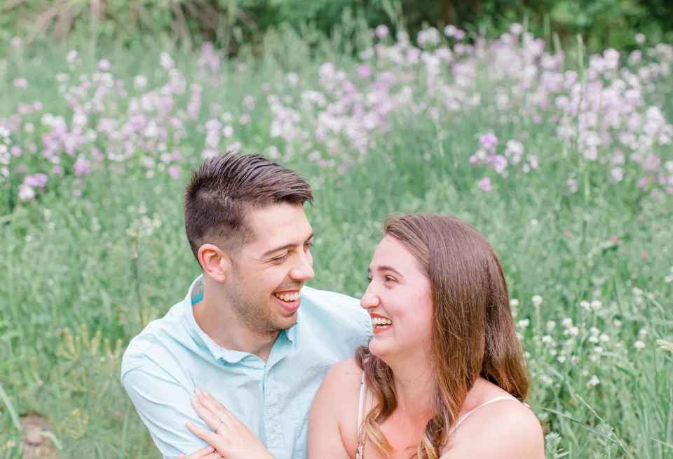 Wild Flower Field Engagement Session - Ideas for what to wear for Engagement Photography, Modern Engagement Session Inspiration Wardrobe Ideas. Unsure of what to wear for your engagement photos, we've got you! Romantic white with Pink Flower dress for Spring Engagement in Ottawa. Grey Loft Studio is Ottawa's Wedding and Engagement Photographer for Real couples, showcasing photos that are modern, bright, and fun.