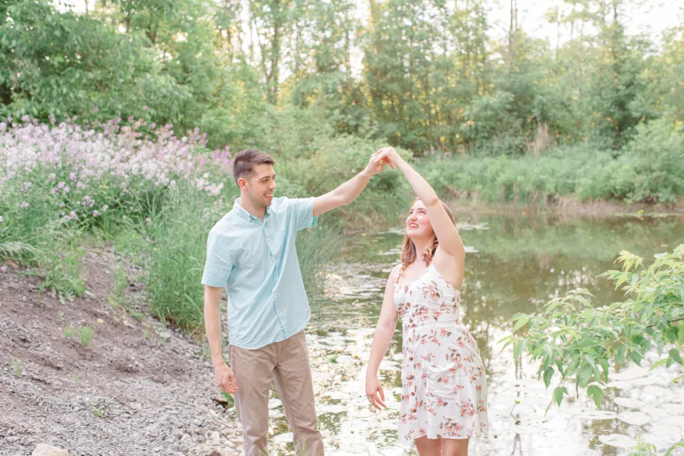 Sunset Inspired Engagement Poses - Ideas for what to wear for Engagement Photography, Modern Engagement Session Inspiration Wardrobe Ideas. Unsure of what to wear for your engagement photos, we've got you! Romantic white with Pink Flower dress for Spring Engagement in Ottawa. Grey Loft Studio is Ottawa's Wedding and Engagement Photographer for Real couples, showcasing photos that are modern, bright, and fun.