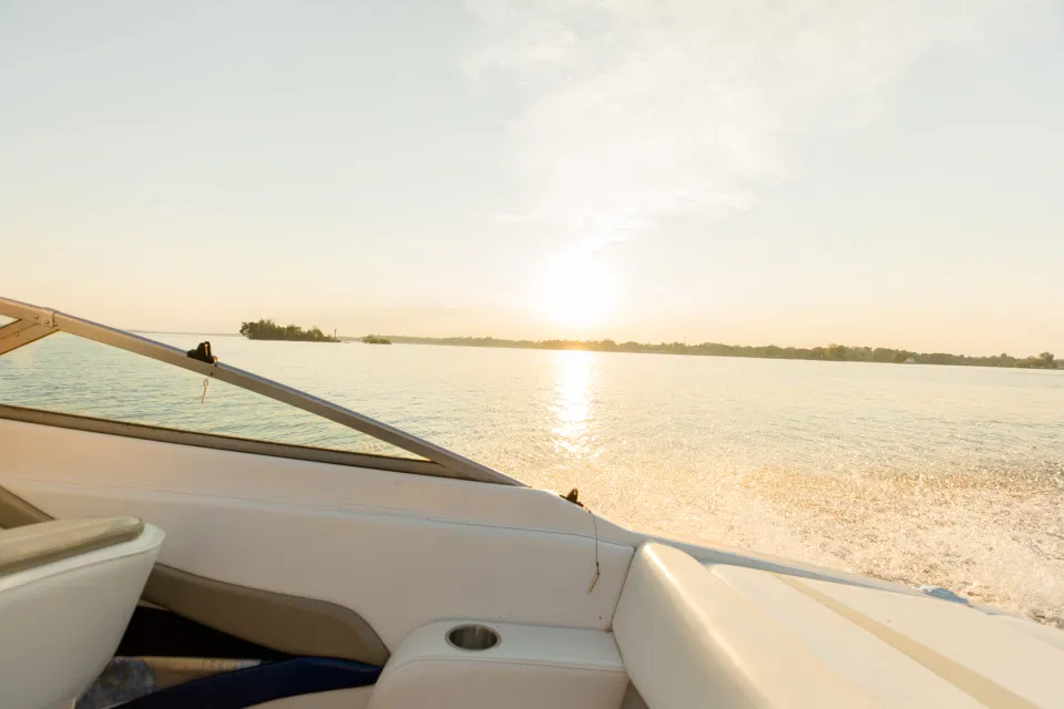 Boat Rides - Ideas for what to wear for Engagement Photography, Modern Engagement Session Inspiration Wardrobe Ideas. Unsure of what to wear for your engagement photos, we've got you! Romantic blue Romper and neutral Shirts and polo. Boat Shoes and Flip Flops. Engagement in Gananoque. Grey Loft Studio is Ottawa's Wedding and Engagement Photographer Videographer for Real couples, showcasing photos that are modern, bright, and fun.