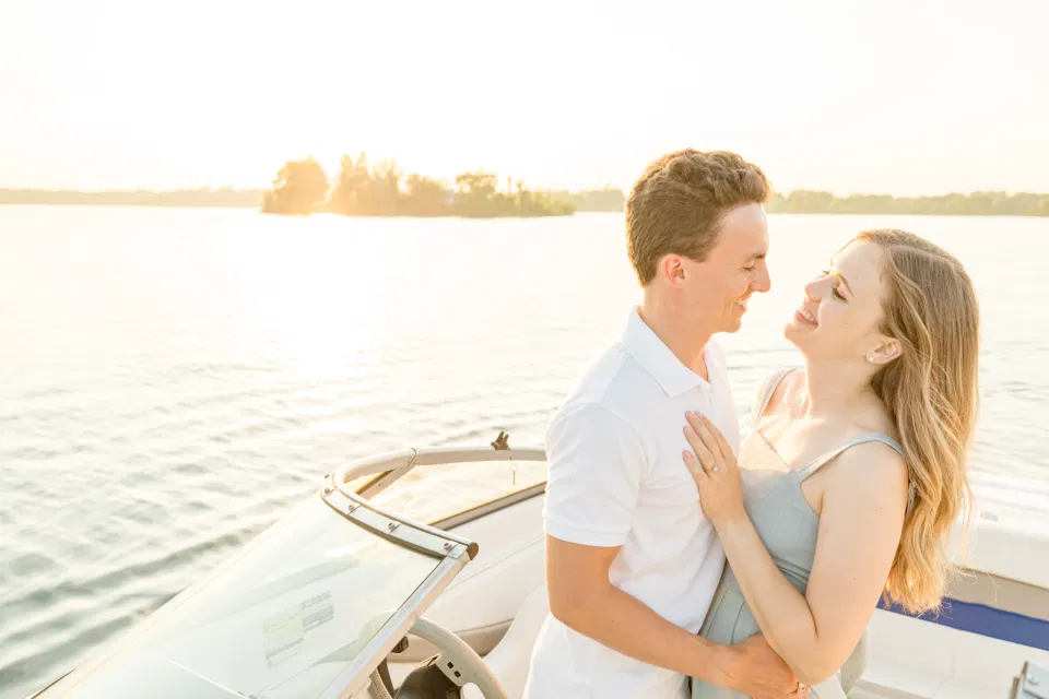 Boat Rides - Ideas for what to wear for Engagement Photography, Modern Engagement Session Inspiration Wardrobe Ideas. Unsure of what to wear for your engagement photos, we've got you! Romantic blue Romper and neutral Shirts and polo. Boat Shoes and Flip Flops. Engagement in Gananoque. Grey Loft Studio is Ottawa's Wedding and Engagement Photographer Videographer for Real couples, showcasing photos that are modern, bright, and fun.