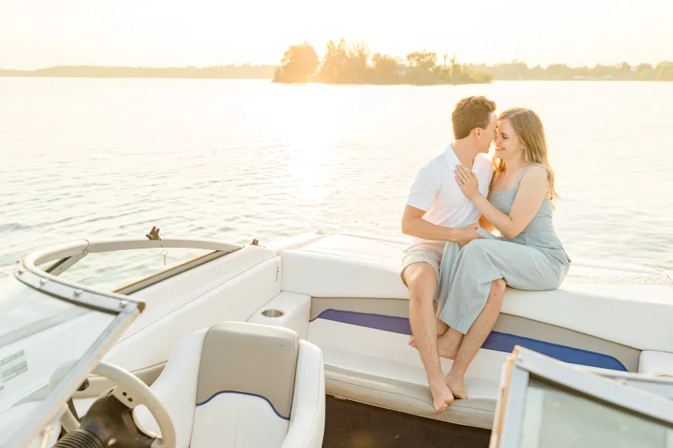 Boat Rides - Ideas for what to wear for Engagement Photography, Modern Engagement Session Inspiration Wardrobe Ideas. Unsure of what to wear for your engagement photos, we've got you! Romantic blue Romper and neutral Shirts and polo. Boat Shoes and Flip Flops. Engagement in Gananoque. Grey Loft Studio is Ottawa's Wedding and Engagement Photographer Videographer for Real couples, showcasing photos that are modern, bright, and fun.
