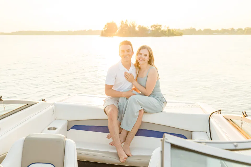 Boat Rides - Ideas for what to wear for Engagement Photography, Modern Engagement Session Inspiration Wardrobe Ideas. Unsure of what to wear for your engagement photos, we've got you! Romantic blue Romper and neutral Shirts and polo. Boat Shoes and Flip Flops. Engagement in Gananoque. Grey Loft Studio is Ottawa's Wedding and Engagement Photographer Videographer for Real couples, showcasing photos that are modern, bright, and fun.