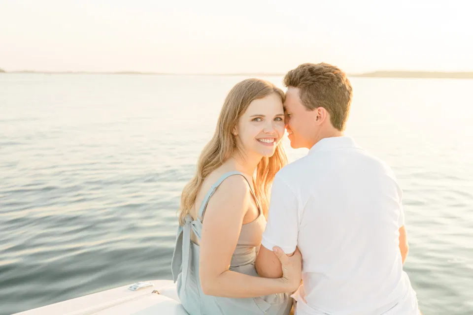 Boat Rides - Ideas for what to wear for Engagement Photography, Modern Engagement Session Inspiration Wardrobe Ideas. Unsure of what to wear for your engagement photos, we've got you! Romantic blue Romper and neutral Shirts and polo. Boat Shoes and Flip Flops. Engagement in Gananoque. Grey Loft Studio is Ottawa's Wedding and Engagement Photographer Videographer for Real couples, showcasing photos that are modern, bright, and fun.