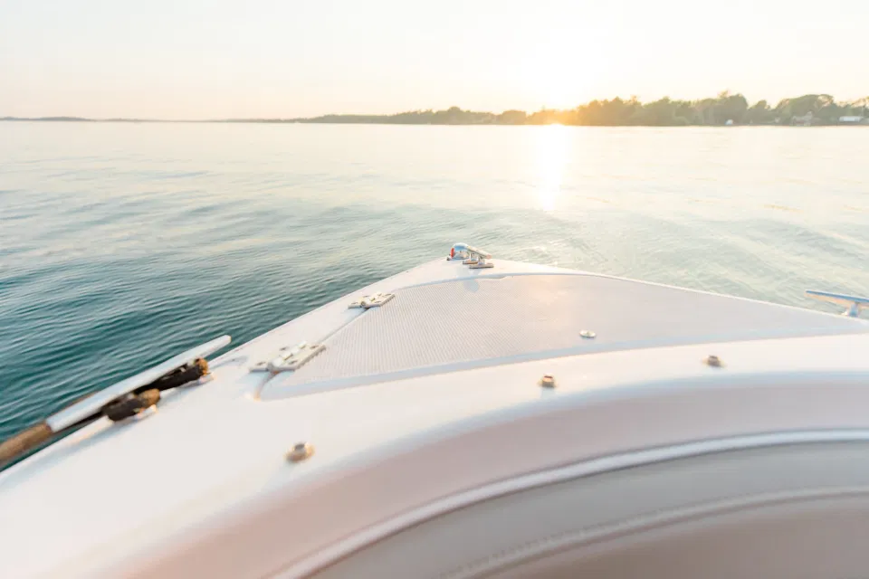 Boat Rides - Ideas for what to wear for Engagement Photography, Modern Engagement Session Inspiration Wardrobe Ideas. Unsure of what to wear for your engagement photos, we've got you! Romantic blue Romper and neutral Shirts and polo. Boat Shoes and Flip Flops. Engagement in Gananoque. Grey Loft Studio is Ottawa's Wedding and Engagement Photographer Videographer for Real couples, showcasing photos that are modern, bright, and fun.