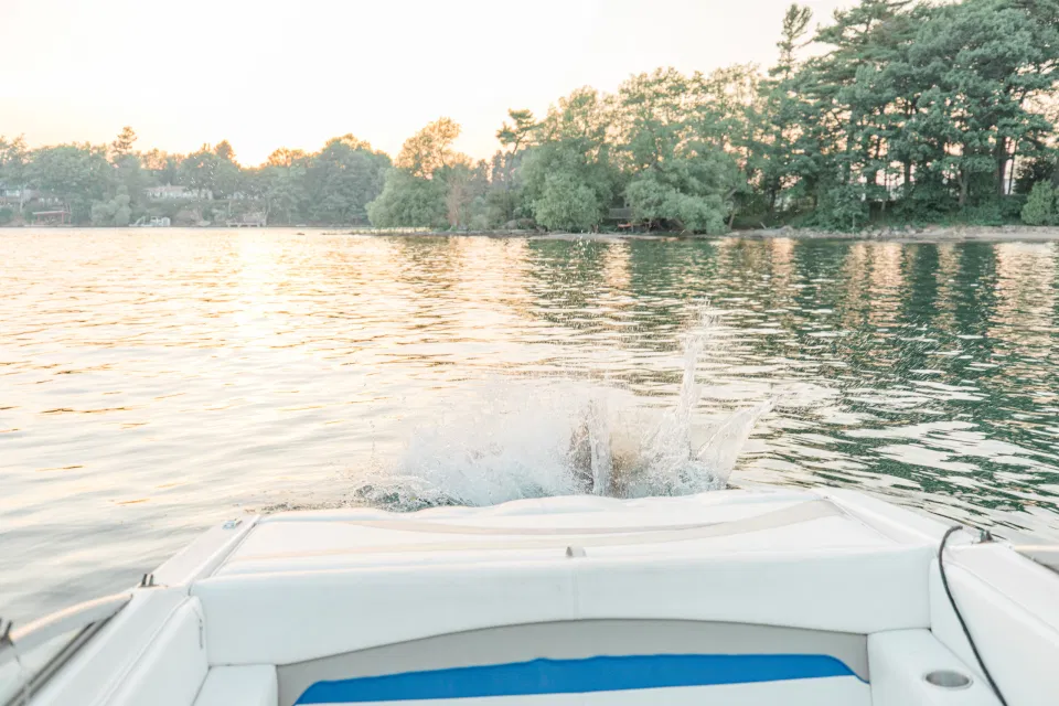 Boat Rides - Ideas for what to wear for Engagement Photography, Modern Engagement Session Inspiration Wardrobe Ideas. Unsure of what to wear for your engagement photos, we've got you! Romantic blue Romper and neutral Shirts and polo. Boat Shoes and Flip Flops. Engagement in Gananoque. Grey Loft Studio is Ottawa's Wedding and Engagement Photographer Videographer for Real couples, showcasing photos that are modern, bright, and fun.